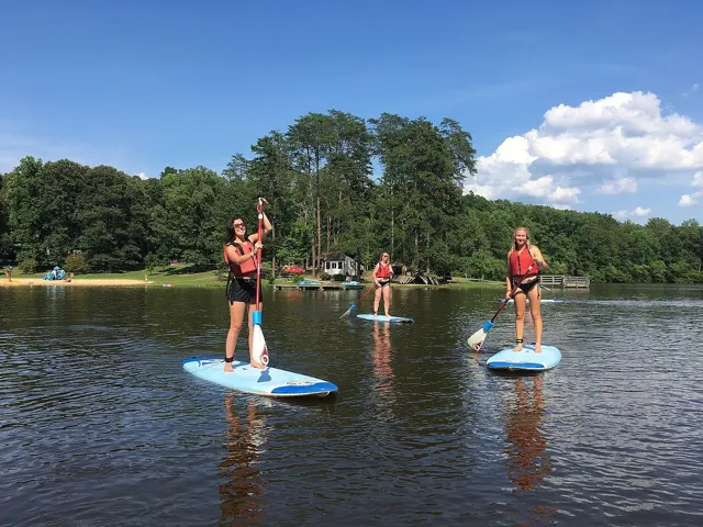 People on stand up paddle boards on a lake